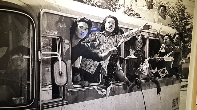 Student protesters in Gwangju, South Korea, lean out of a bus during a pro-democracy demonstration on May 18, 1980